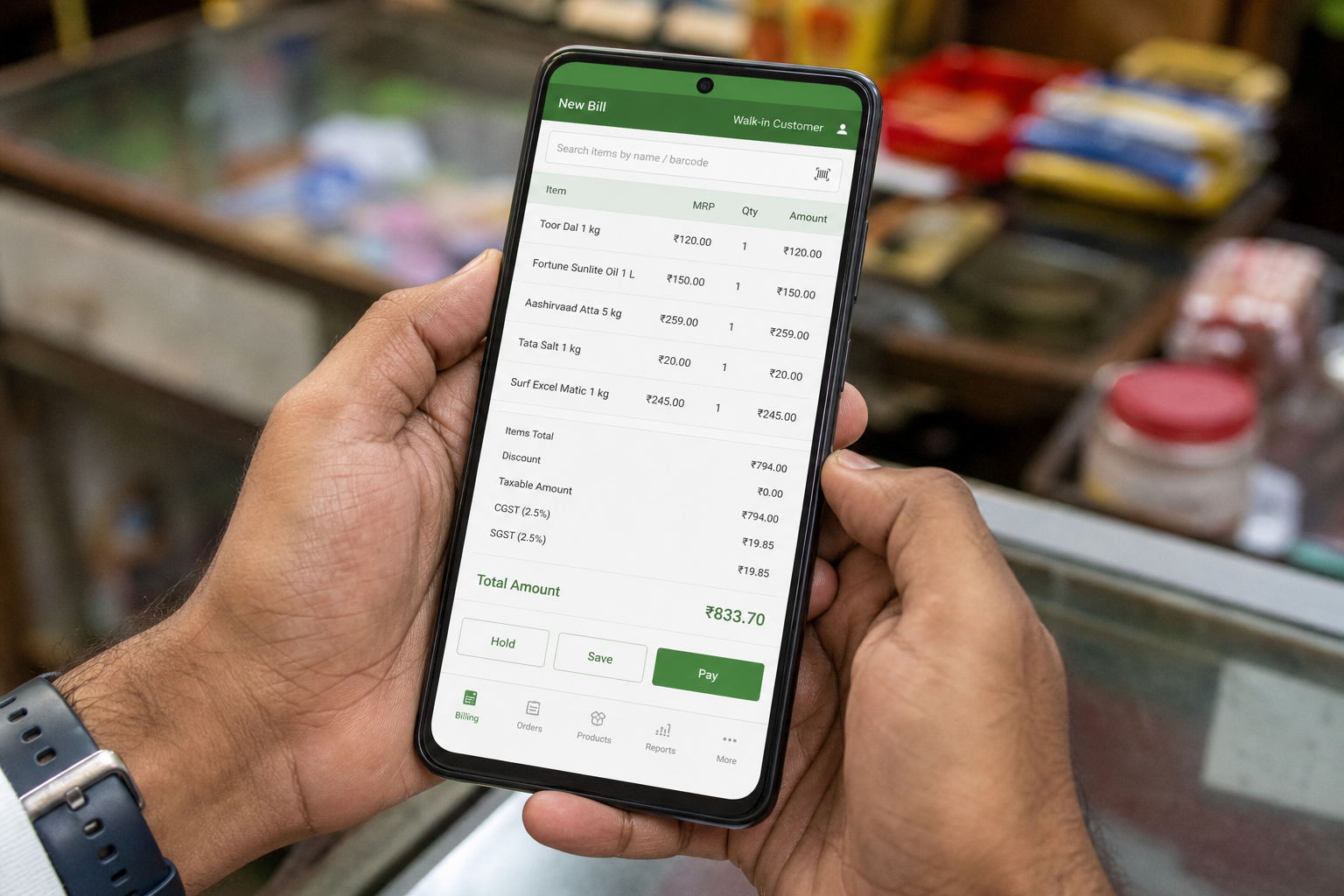 Retail billing on a smartphone at an Indian shop counter